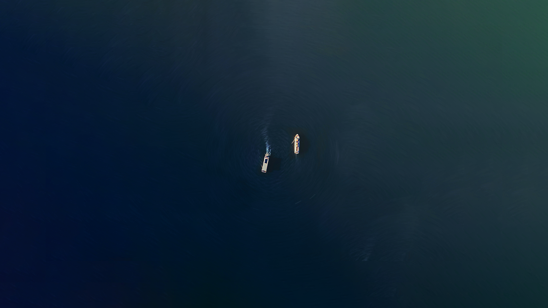 Aerial view of boats on deep ocean waters
